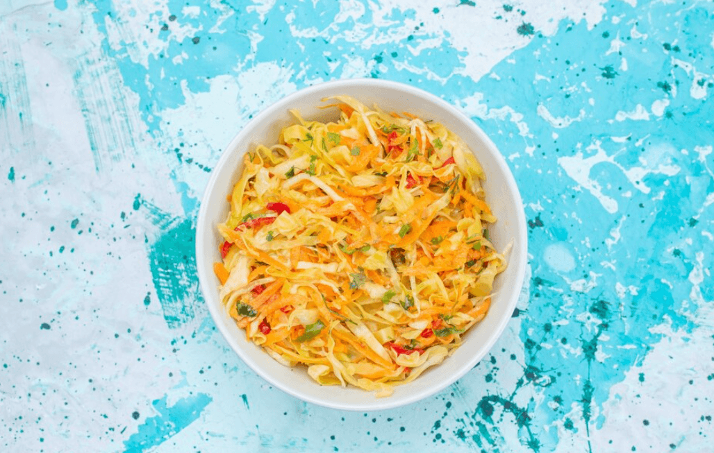 Fennel orange salad served on a white plate with fresh mint and olive oil drizzle